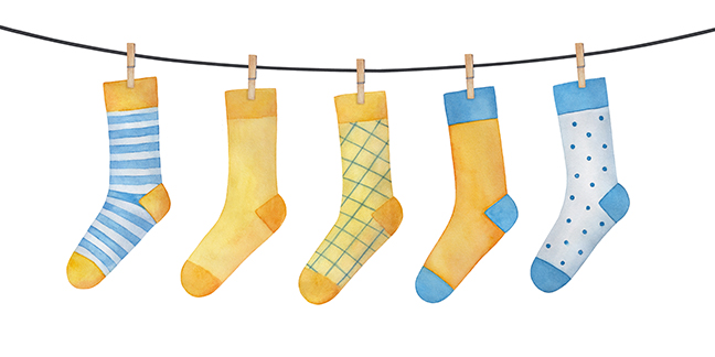 Various colorful socks on clothesline. Striped, checkered, polka